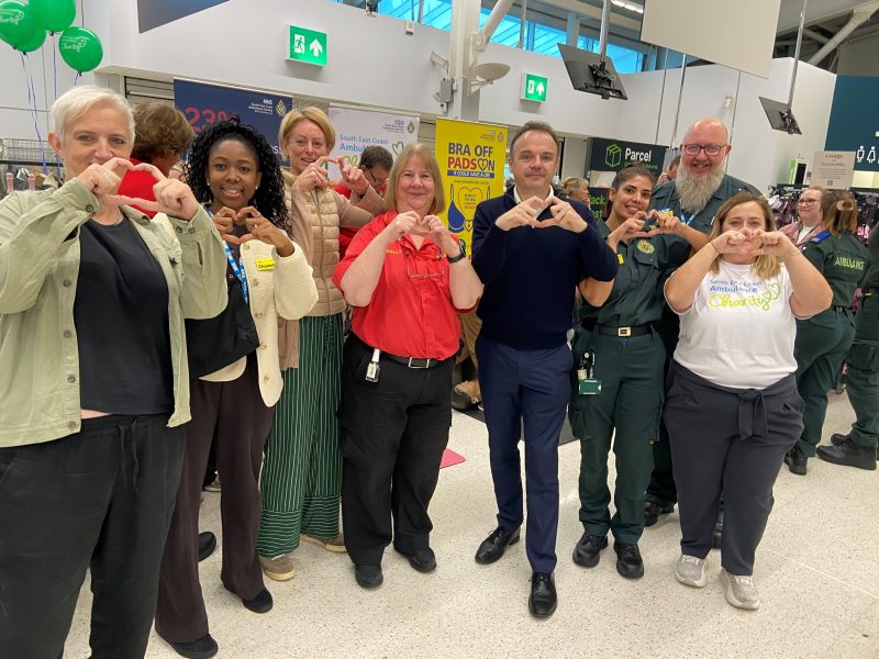 MP Tris Osborne and SECAmb colleagues pose for Restart a Heart day with hands in a heart shape.